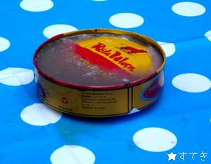 にごった汁のなかに沈む缶のフタ。テーブルクロスに不吉な汁のシミが…